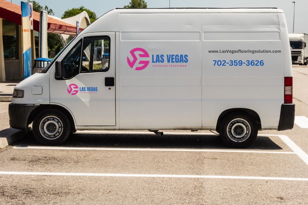 A white van in a parking lot, showcasing flooring services offered in Las Vegas, NV.