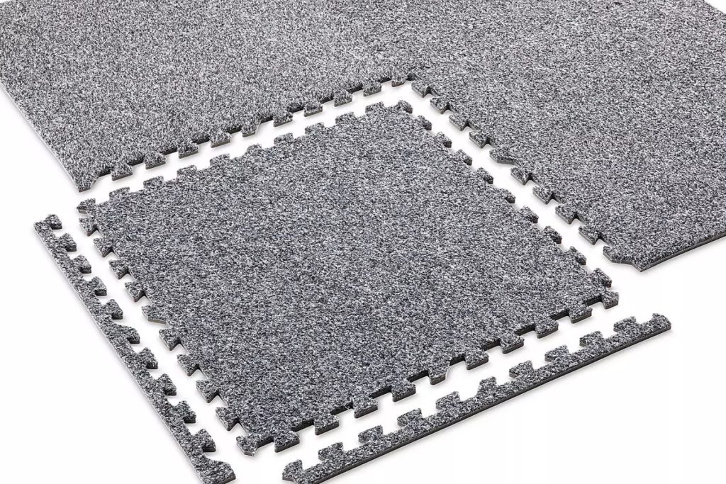 Four grey felt tiles displayed together, representing carpet tile flooring services available in Las Vegas, NV.