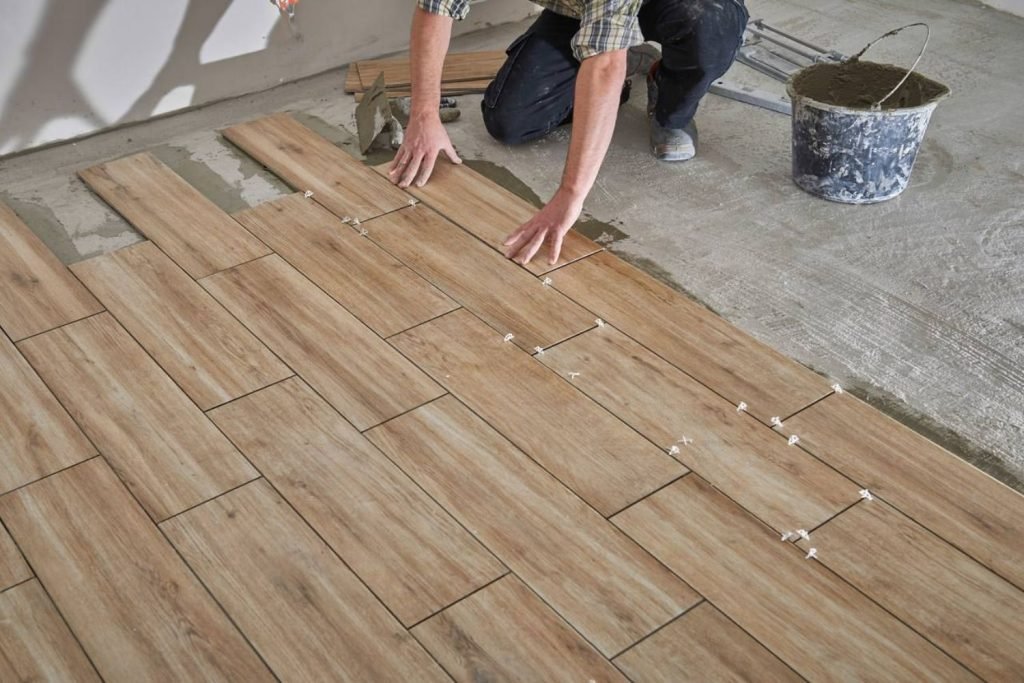 A man working on hardwood flooring installation, representing flooring services in Las Vegas, NV.