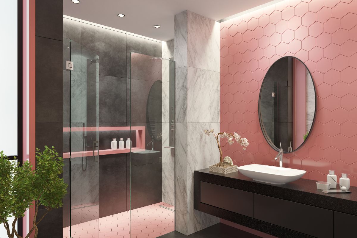 A contemporary bathroom featuring pink walls complemented by stylish black and white tiled flooring.