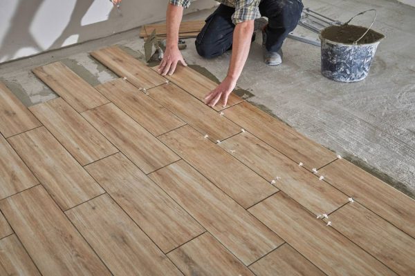 A man working on hardwood flooring installation, representing flooring services in Las Vegas, NV.